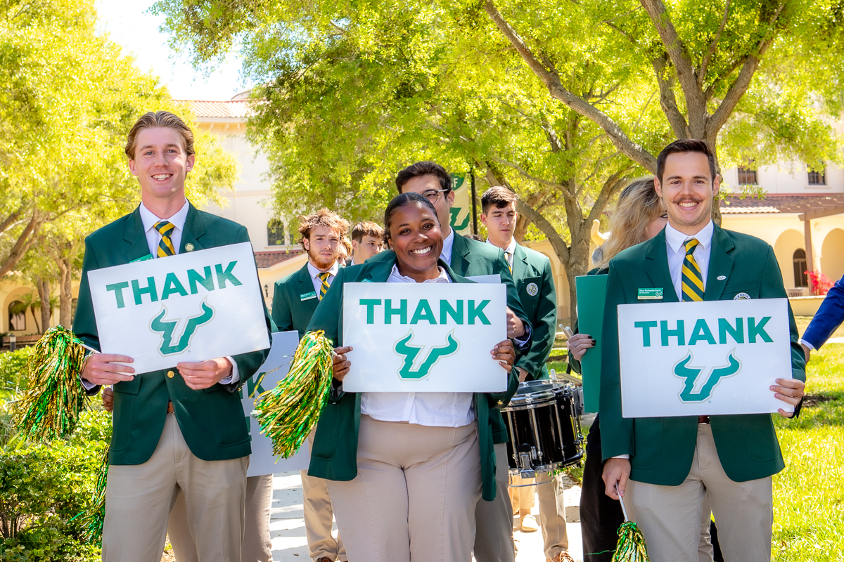 Ambassadors holding Thank Bull U signs