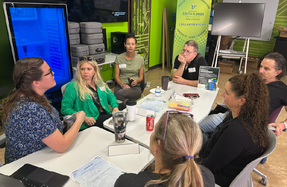 Adults meeting at a table in the collaboratory