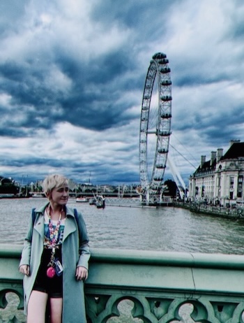 Graduate student standing in front of ferris wheel