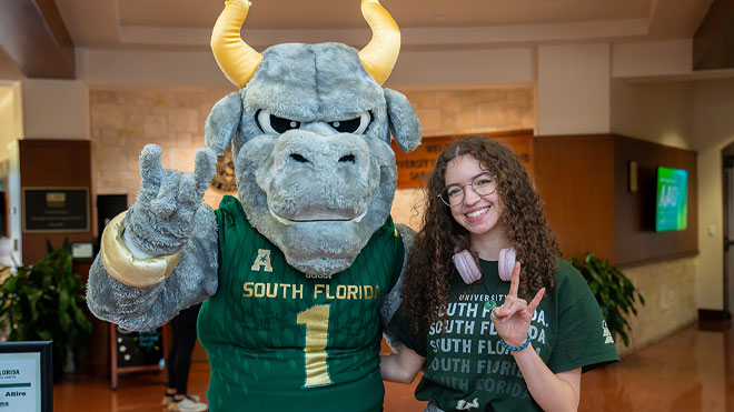 Rocky and student showing the horns hand signal