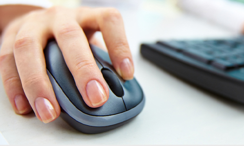 Hand holding a computer mouse