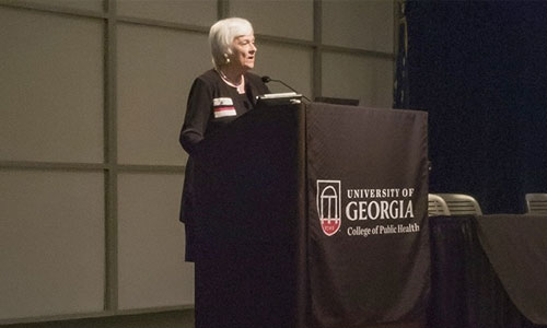 Karen Holbrook speaking at a podium