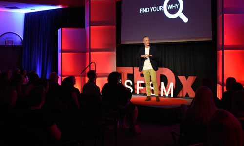 TEDxUSFSM speaker on stage.