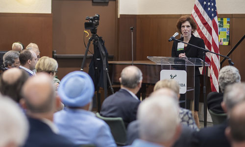 Woman speaking to a room of people.