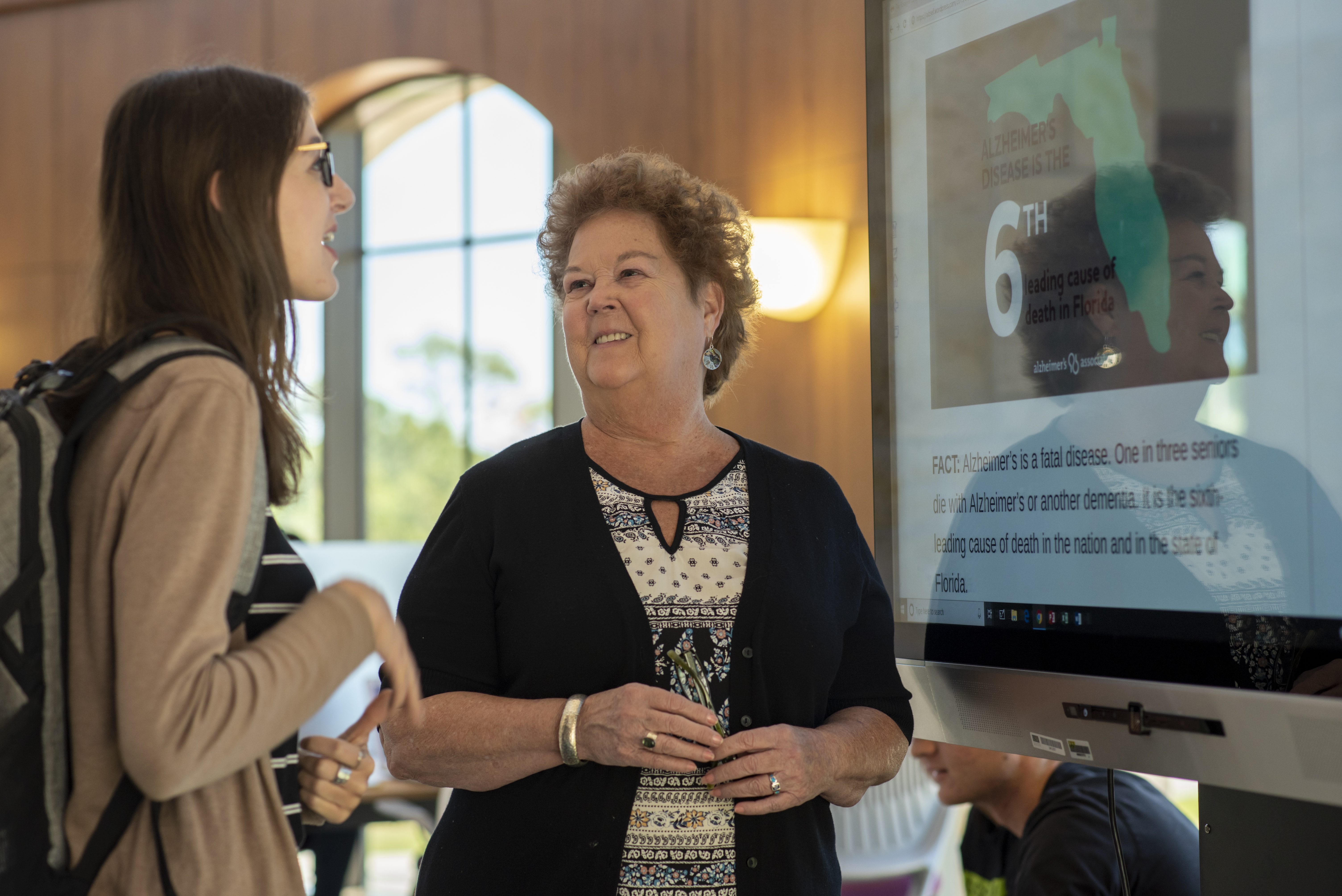 Jane Roberts talking with student