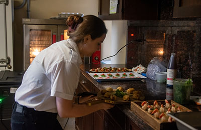 A student in the School of Hospitality and Tourism Management prepares food