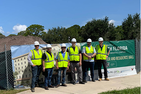 Construction workers outside new student housing building