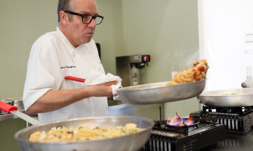 Chef Thompson tossing pasta during his demonstration