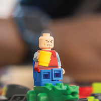 Middle school student using legos for learning and research.