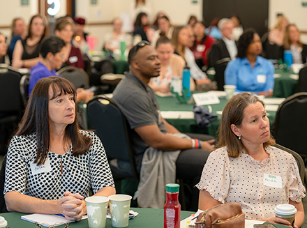 Audience members at Duvall Conference sit at tables in Student Center Ballroom at USF Sarasota-Manatee.