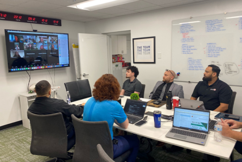 Interns in a meeting with leaders in conference room