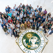 faculty group photo looking up at camera 